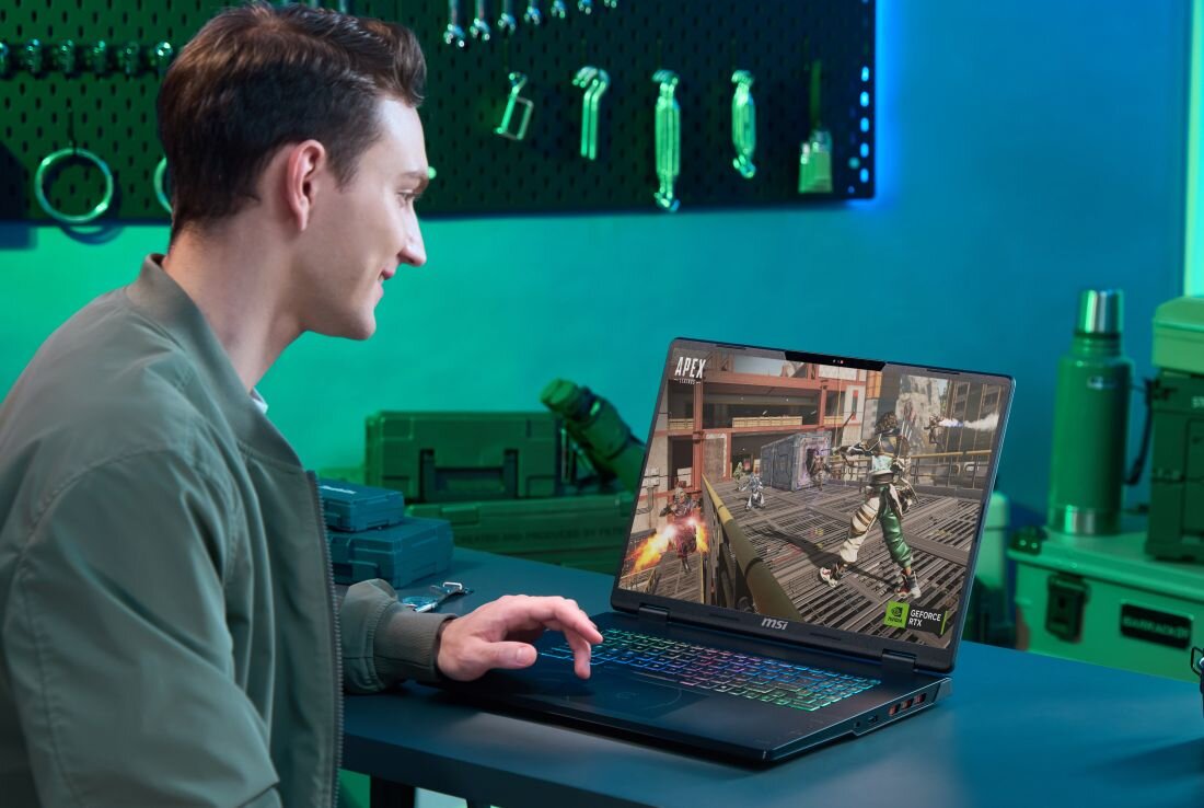 Osoba gra na laptopie MSI Crosshair z kartą GeForce RTX przy biurku gamingowym w nowoczesnym pomieszczeniu – Bateria 90 Wh