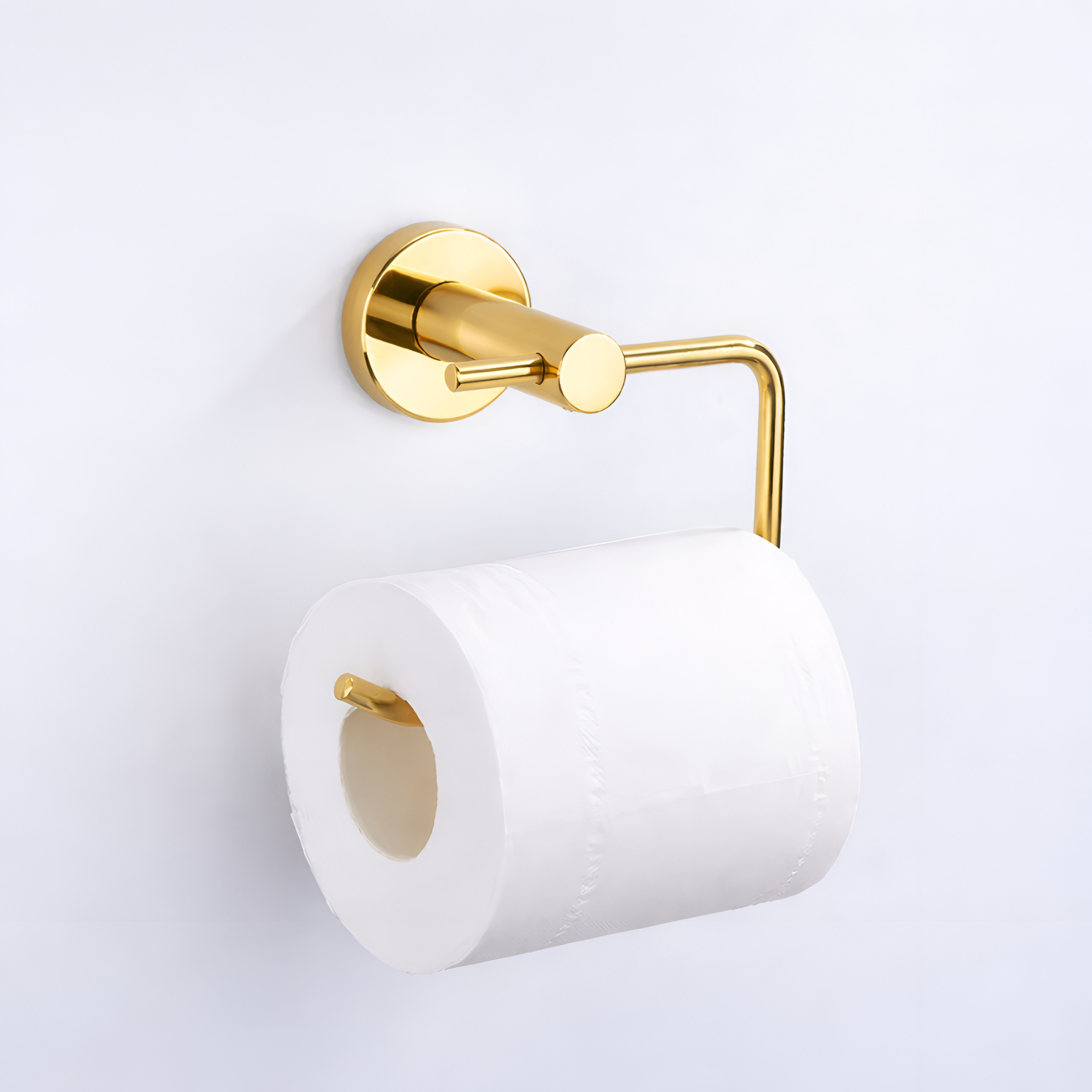 Metalowy uchwyt na papier toaletowy w złotym połysku zamontowany na ścianie, z rolką białego papieru toaletowego.