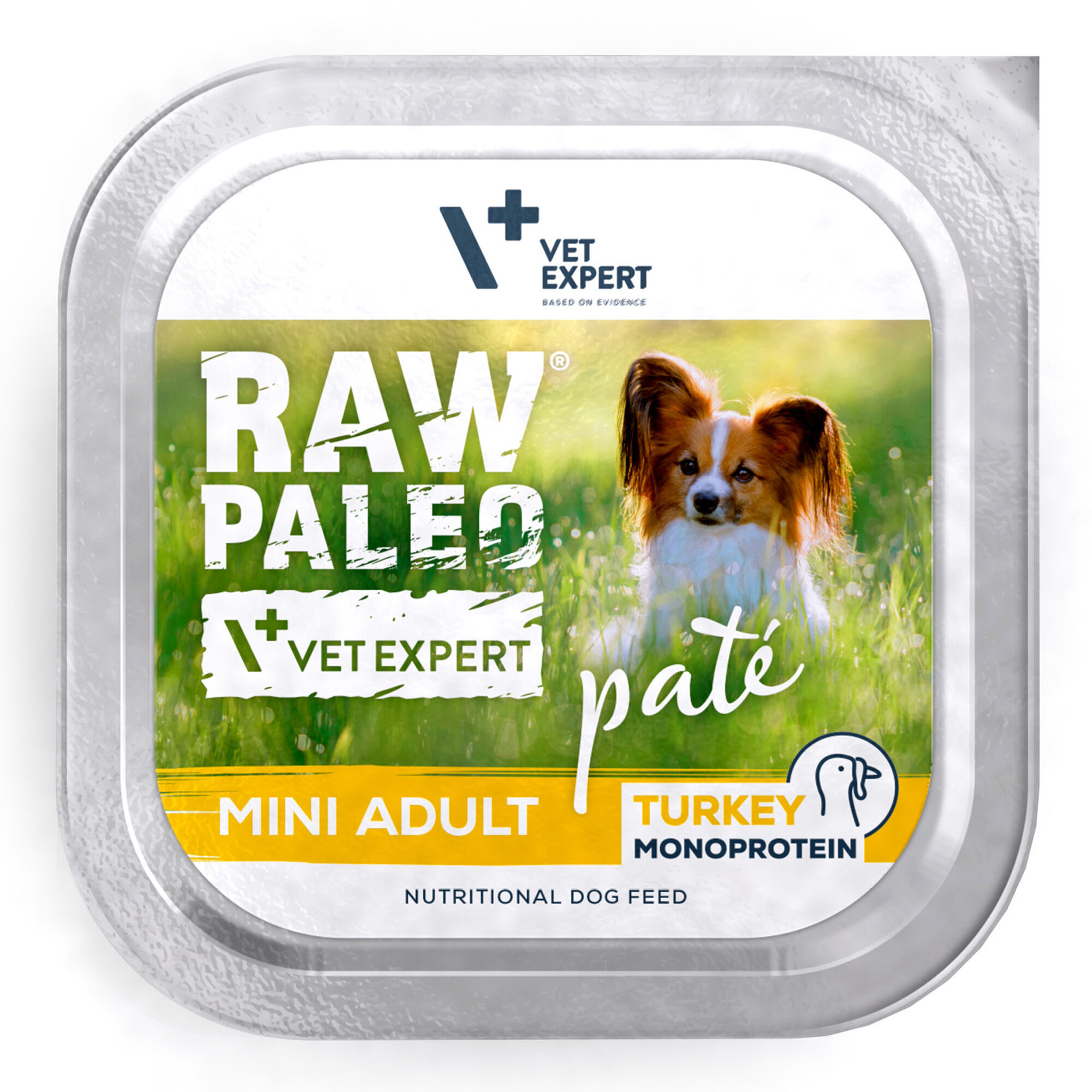 Opakowanie mokrej karmy dla psów z napisem \'RAW PALEO\', \'VET EXPERT\', \'pate\', \'MINI ADULT\', \'TURKEY MONOPROTEIN\'. Widoczny jest obrazek psa na tle trawy.