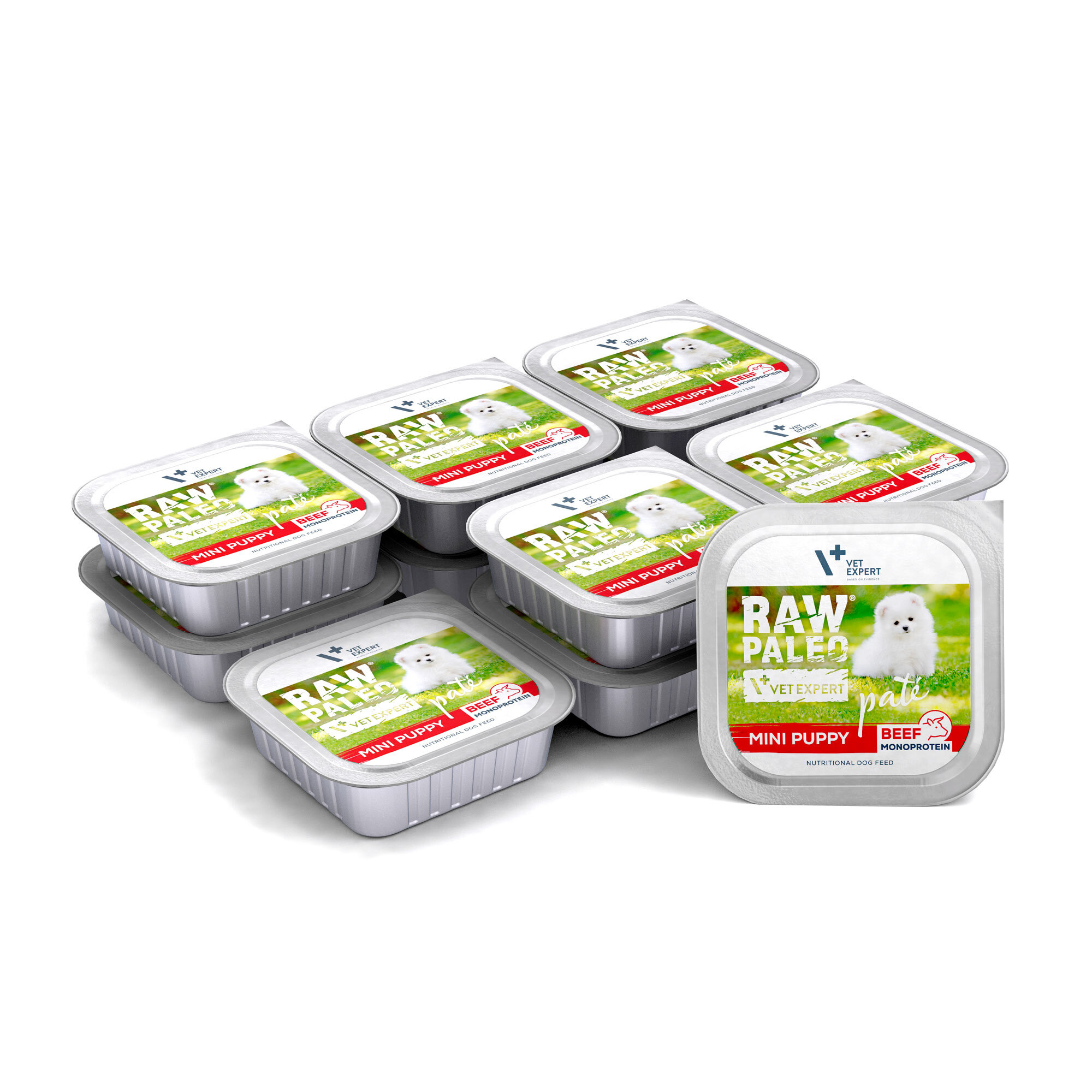 Na obrazie widoczne są opakowania mokrej karmy dla szczeniąt z napisem \'RAW PALEO MINI PUPPY BEEF\'. Na etykiecie znajduje się zdjęcie białego szczeniaka na tle zielonej trawy.