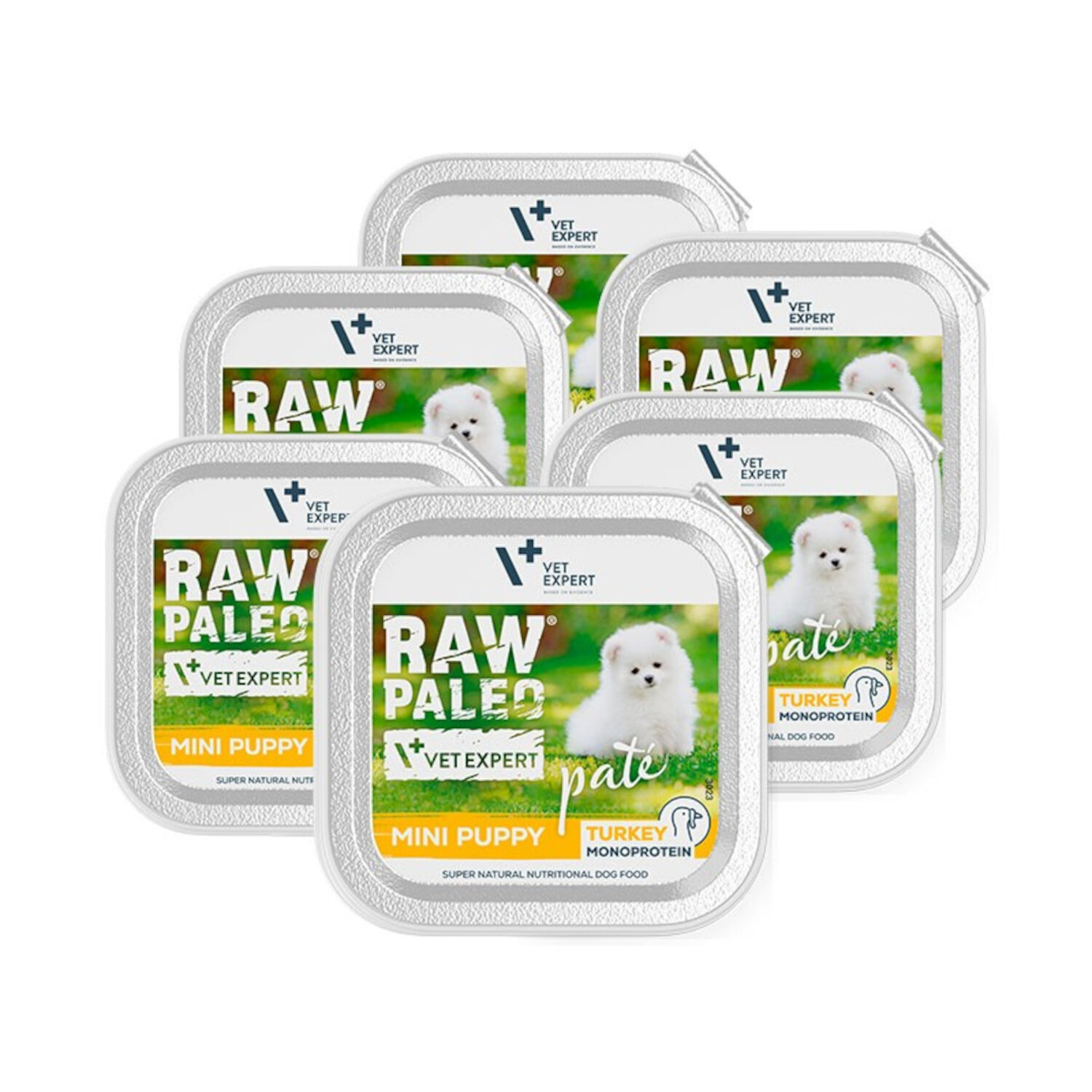 Na obrazie widoczne są sześć opakowań mokrej karmy dla szczeniąt z napisem \'RAW PALEO MINI PUPPY\' oraz \'TURKEY MONOPROTEIN\'. Na etykiecie znajduje się zdjęcie białego szczeniaka na tle trawy.