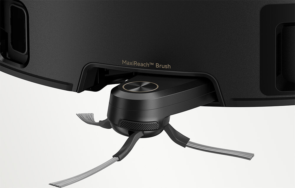 Zbliżenie na szczotkę robota sprzątającego z napisem \'MaxiReach™ Brush\'. Szczotka ma kilka elastycznych włókien i jest zamontowana na ciemnej obudowie urządzenia.