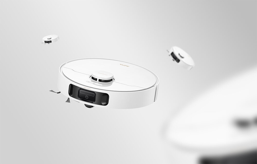 Na obrazie widoczny jest biały robot sprzątający z logo \'MOVA\' na górze. Robot ma okrągły kształt i czarny panel z przodu.