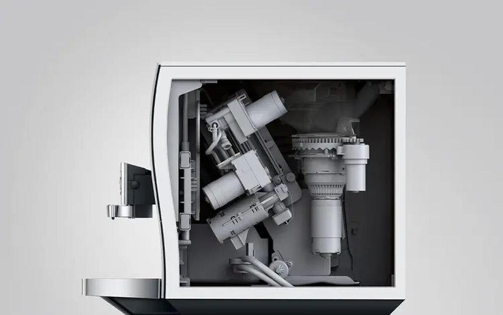 Wnętrze ekspresu do kawy z widocznymi elementami mechanicznymi i rurkami. Obudowa jest w kolorze białym.