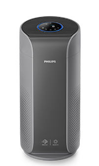 Na obrazie widoczny jest szary oczyszczacz powietrza z logo PHILIPS na przedniej części. Urządzenie ma okrągły panel sterowania na górze z niebieskim podświetleniem.
