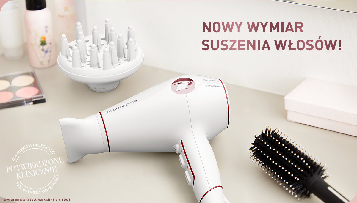 Na obrazie znajduje się biała suszarka do włosów z czerwonymi akcentami, obok której leży dyfuzor i szczotka. Widoczny jest tekst: \'NOWY WYMIAR SUSZENIA WŁOSÓW!\' oraz \'POTWIERDZONE KLINICZNIE\'.