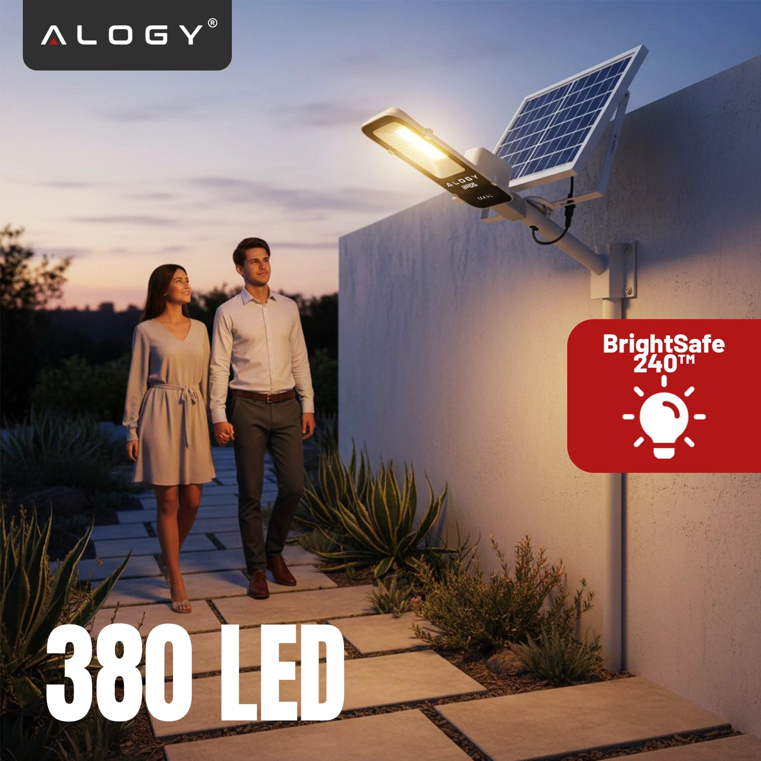Na obrazie widoczna jest lampa solarna zamontowana na ścianie, oświetlająca ścieżkę, przy której idzie para. W lewym górnym rogu znajduje się logo \'ALOGY\', a na dole napis \'380 LED\'.