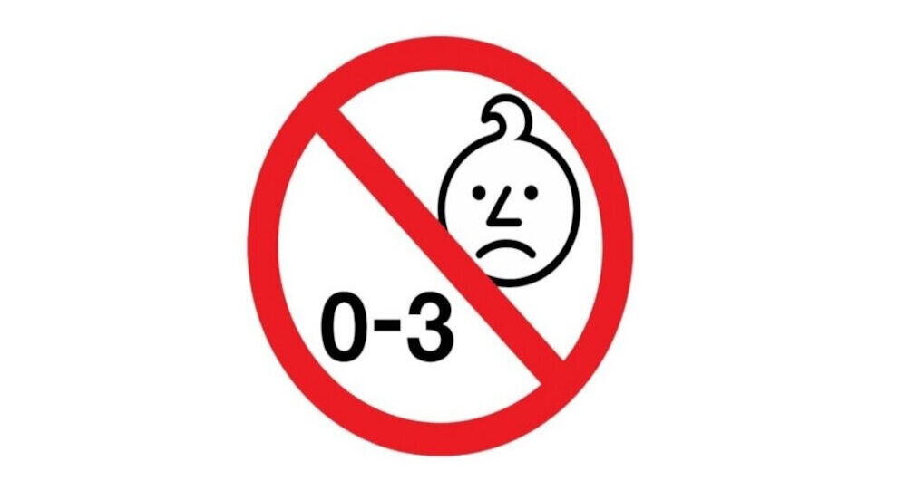 Symbol przedstawia przekreśloną czerwoną linią twarz dziecka z cyframi \'0-3\'.