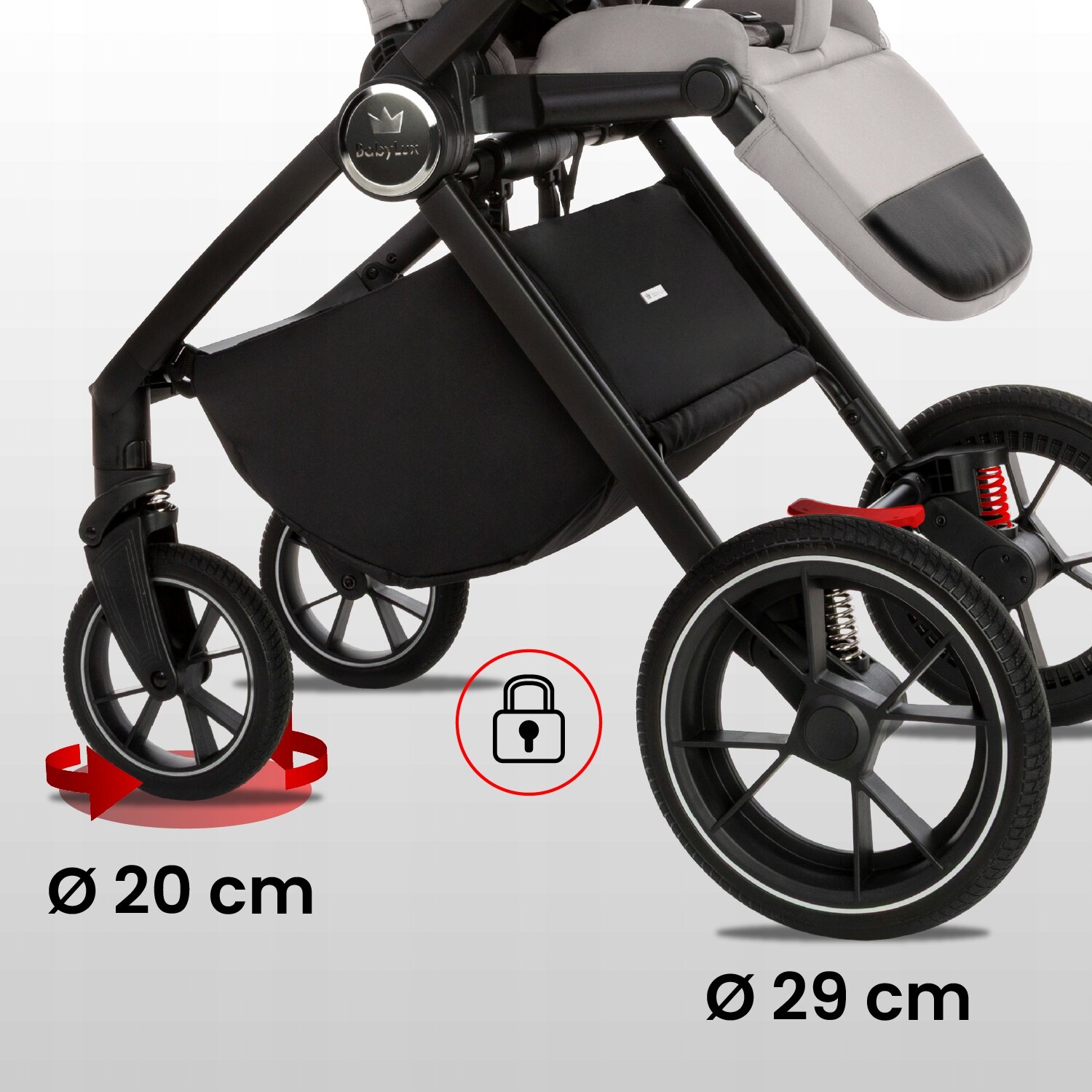 Obraz przedstawia dolną część wózka dziecięcego z widocznymi kołami o średnicach 20 cm i 29 cm. Na wózku znajduje się logo \'BabyLux\', a obok kół widoczna jest ikona kłódki w czerwonym okręgu.