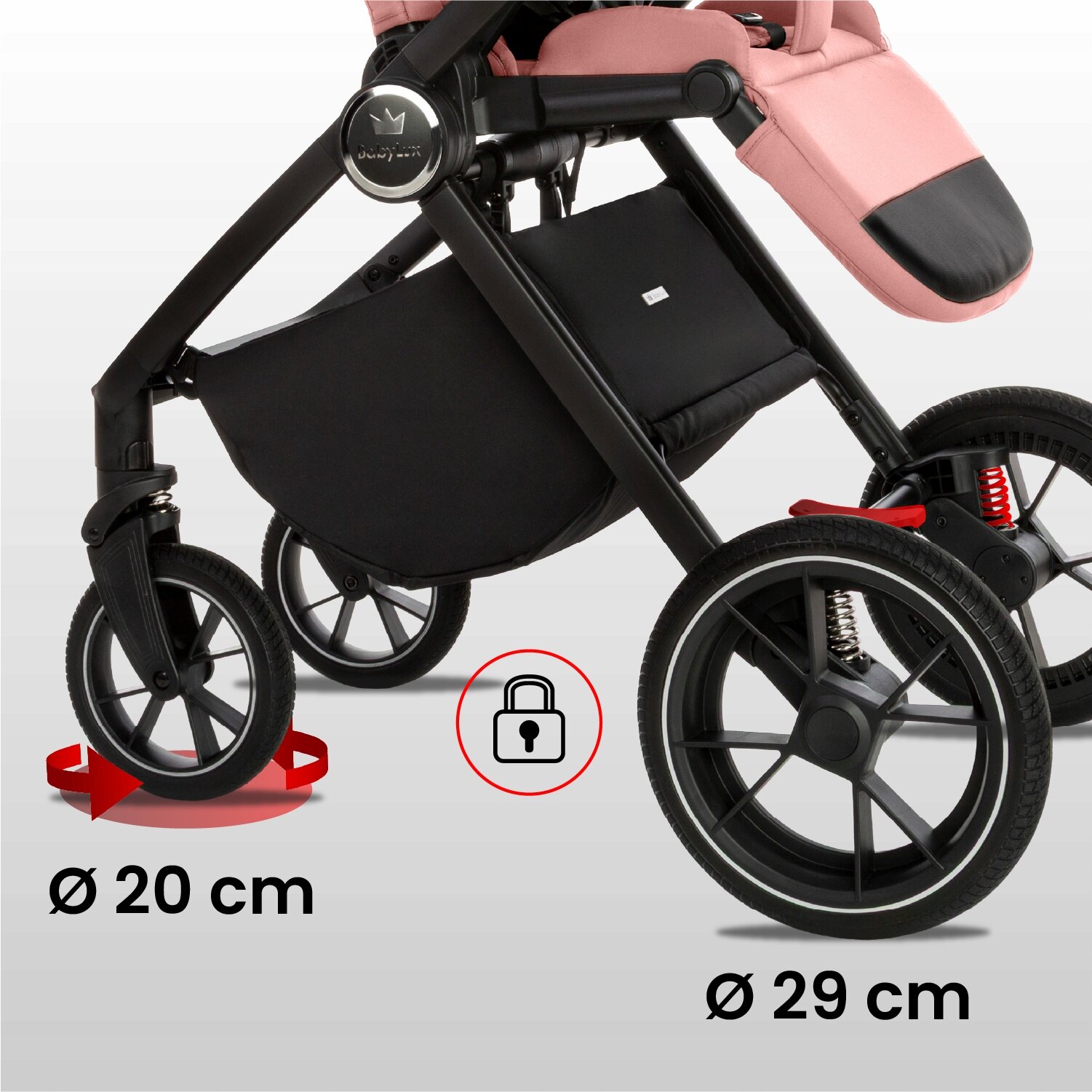 Obraz przedstawia dolną część wózka dziecięcego z czarnymi kołami i różowym siedziskiem. Widoczne są wymiary kół: 20 cm i 29 cm oraz ikona kłódki w czerwonym okręgu.
