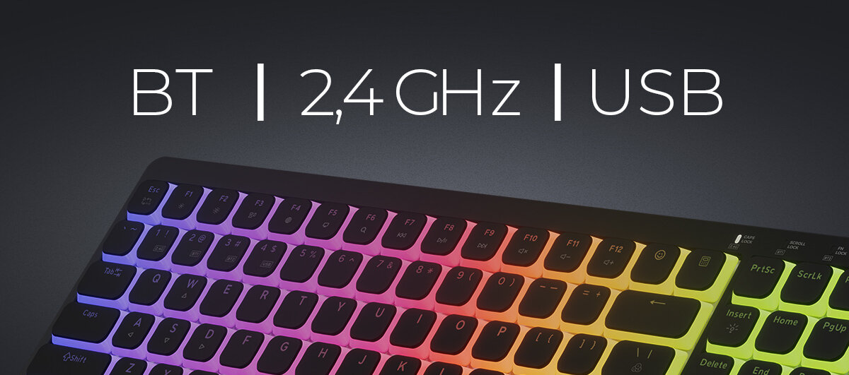 Zdjęcie klawiatury gamingowej Genesis z podświetleniem RGB, nad klawiaturą widnieje napis 'BT| 2,4 GHz| USB'.
