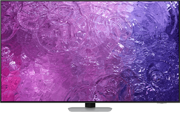 Telewizor z wyświetlaczem OLED prezentujący abstrakcyjny wzór w odcieniach fioletu i różu. Urządzenie stoi na prostokątnej podstawie.