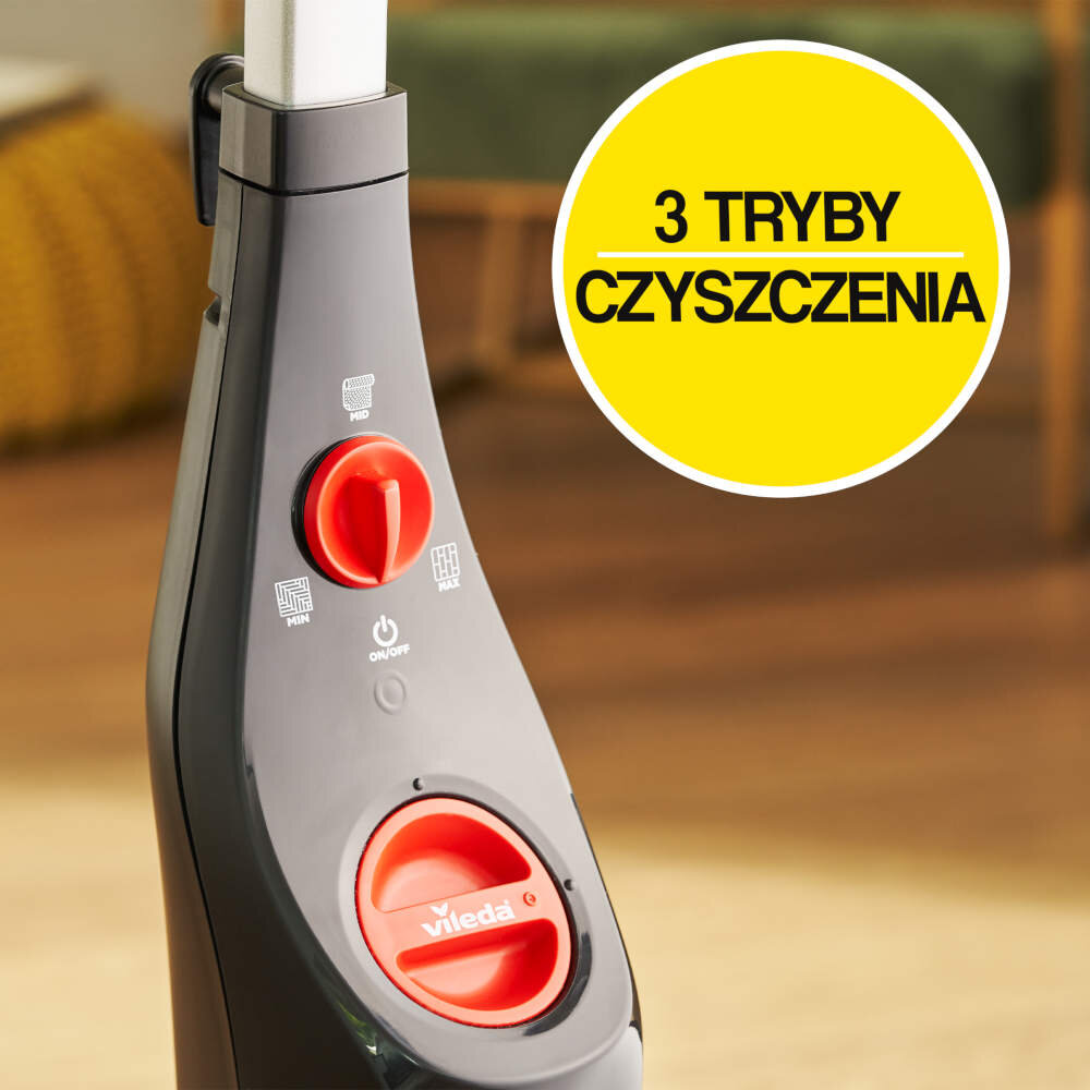 Czarny panel sterowania mopa parowego z czerwonym pokrętłem i przyciskiem włączania. Na żółtym tle napis: \'3 TRYBY CZYSZCZENIA\'.