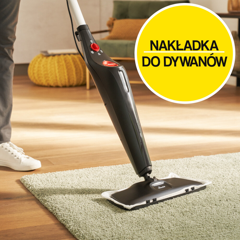 Czarny mop parowy z czerwonymi przyciskami stoi na dywanie. Obok widoczny jest żółty okrąg z napisem \'NAKŁADKA DO DYWANÓW\'.