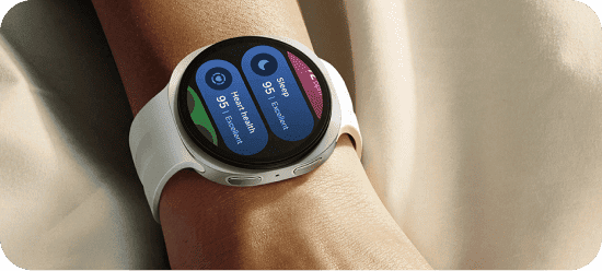 Galaxy Watch na nadgarstku wyświetla dane o tętnie, stresie i śnie. Na zdjęciu widoczny jest smartwatch z białym paskiem na nadgarstku, z wyświetlaczem pokazującym dane dotyczące snu i zdrowia serca. Tło jest jednolite i jasne.