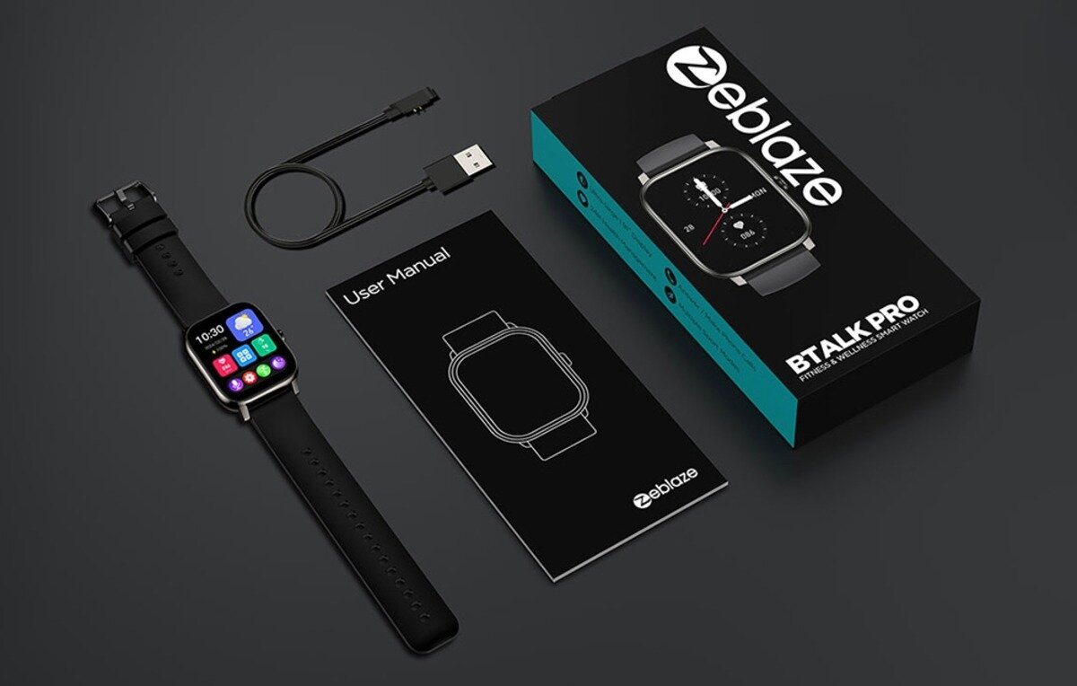 Na obrazie znajduje się smartwatch z kolorowym wyświetlaczem, czarnym paskiem, kabel USB, instrukcja obsługi z napisem \'User Manual\' oraz pudełko z logo \'zeblaze\' i napisem \'BTALK PRO\'.