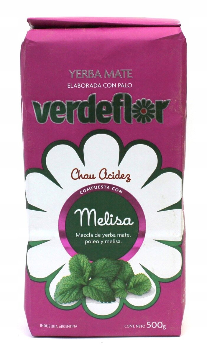 Opakowanie Yerba Mate Verdeflor Melisa 500g w kolorze różowym z dużym białym kwiatem na środku. Widoczny tekst: \'Yerba Mate\', \'verdeflor\', \'Chau Acidez\', \'Melisa\', \'Mezcla de yerba mate, poleo y melisa\', \'Industria Argentina\', \'Cont. Neto 500g\'.