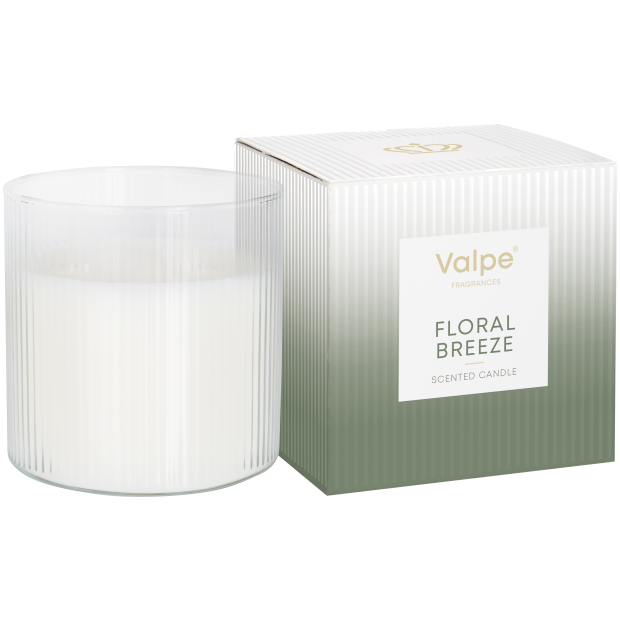 Na obrazie widoczna jest świeca w prążkowanym szkle obok pudełka z napisem \'Valpe FRAGRANCES FLORAL BREEZE SCENTED CANDLE\'.