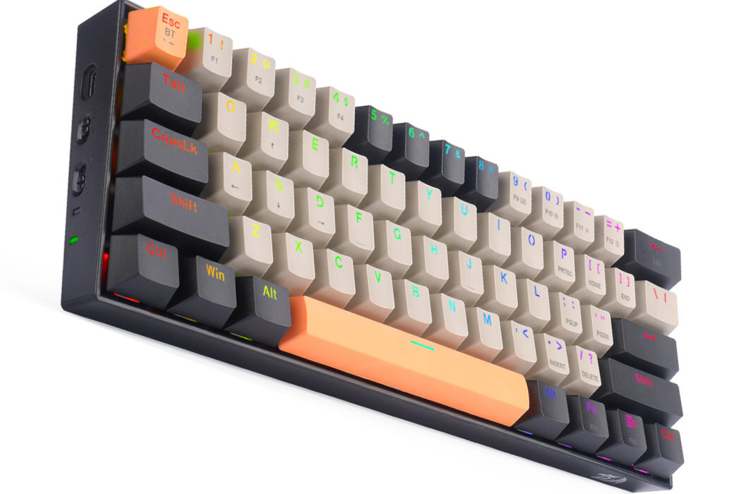 Klawiatura mechaniczna z kolorowymi klawiszami, w tym pomarańczowym klawiszem spacji i ciemnymi klawiszami funkcyjnymi. Widoczne są oznaczenia takie jak \'Esc\', \'Ctrl\', \'Win\', \'Alt\'.