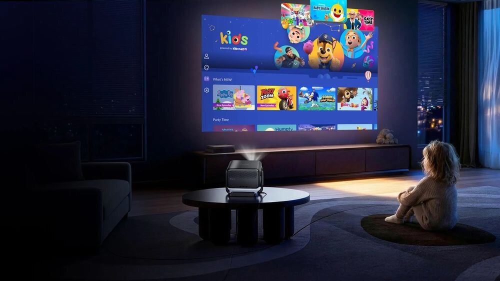 Platforma Kidoodle TV w projektorze Dangbei N3 Max z kolorowym menu programów dla dzieci, projektor na stoliku wyświetlający obraz na ścianie