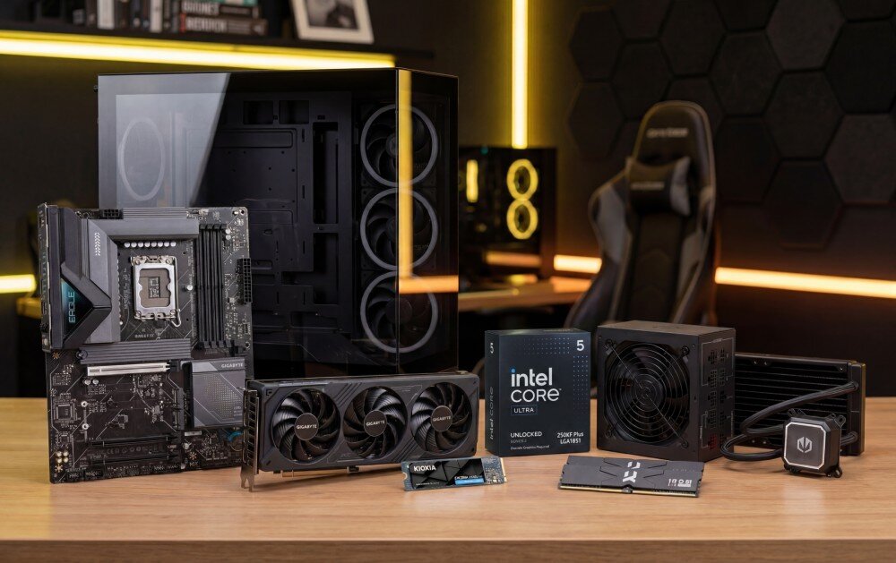 Na drewnianym stole znajdują się komponenty komputerowe, w tym obudowa, płyta główna, karta graficzna, procesor z napisem \'intel core i5 unlocked\', zasilacz oraz chłodzenie wodne. W tle widoczne jest krzesło gamingowe i ściana z heksagonalnymi panelami.