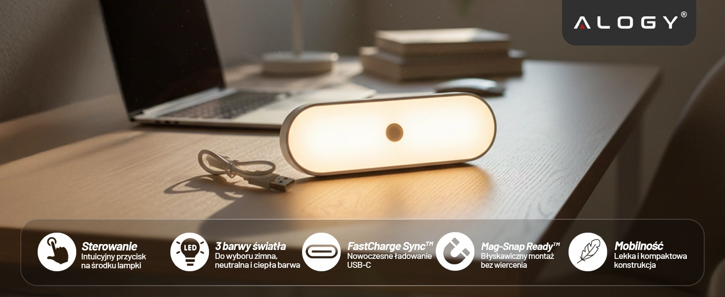 Na drewnianym biurku znajduje się podłużna, biała lampka LED z okrągłym przyciskiem na środku, obok której leży kabel USB. W tle widoczny jest otwarty laptop, a w prawym górnym rogu znajduje się logo \'ALOGY\'.