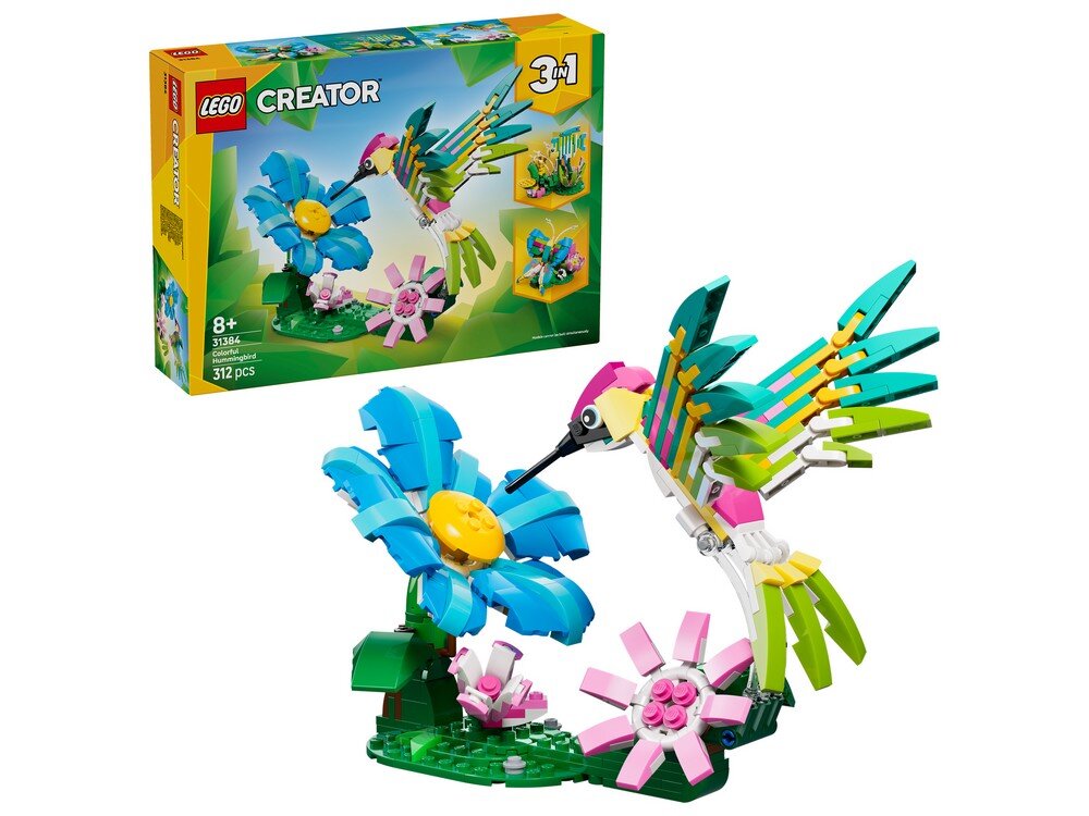Zestaw LEGO przedstawia kolorowego kolibra unoszącego się nad dużym, niebieskim kwiatem z żółtym środkiem. W tle widoczne jest pudełko z napisem \'LEGO CREATOR 3in1\'.