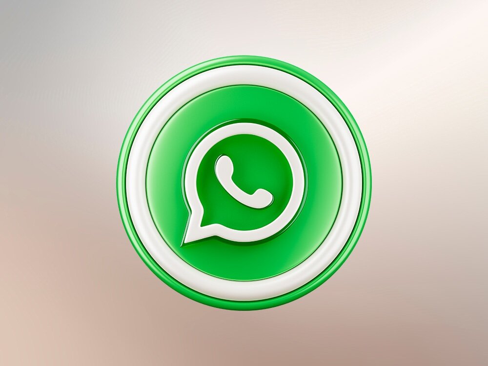 Obraz przedstawia zieloną ikonę z białym symbolem dymka i słuchawki, charakterystyczną dla aplikacji WhatsApp.