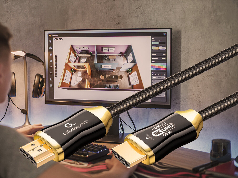 Na obrazie widać osobę siedzącą przy biurku z monitorem, na którym wyświetlany jest plan pomieszczenia. Na pierwszym planie znajduje się kabel HDMI z napisami \'cablexpert\' i \'HDMI 2.1 8K UHD 60 Hz\'.