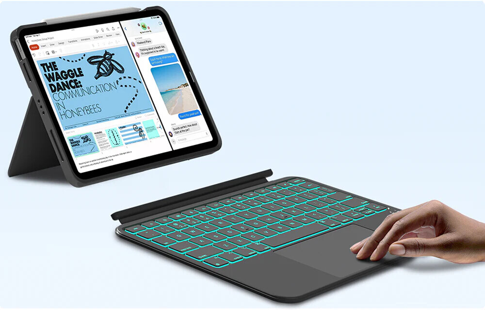 Obraz przedstawia iPad z otwartą aplikacją oraz czarną klawiaturę z podświetleniem. Na ekranie widoczny jest tekst: \'THE WAGGLE DANCE COMMUNICATION IN HONEYBEES\'.