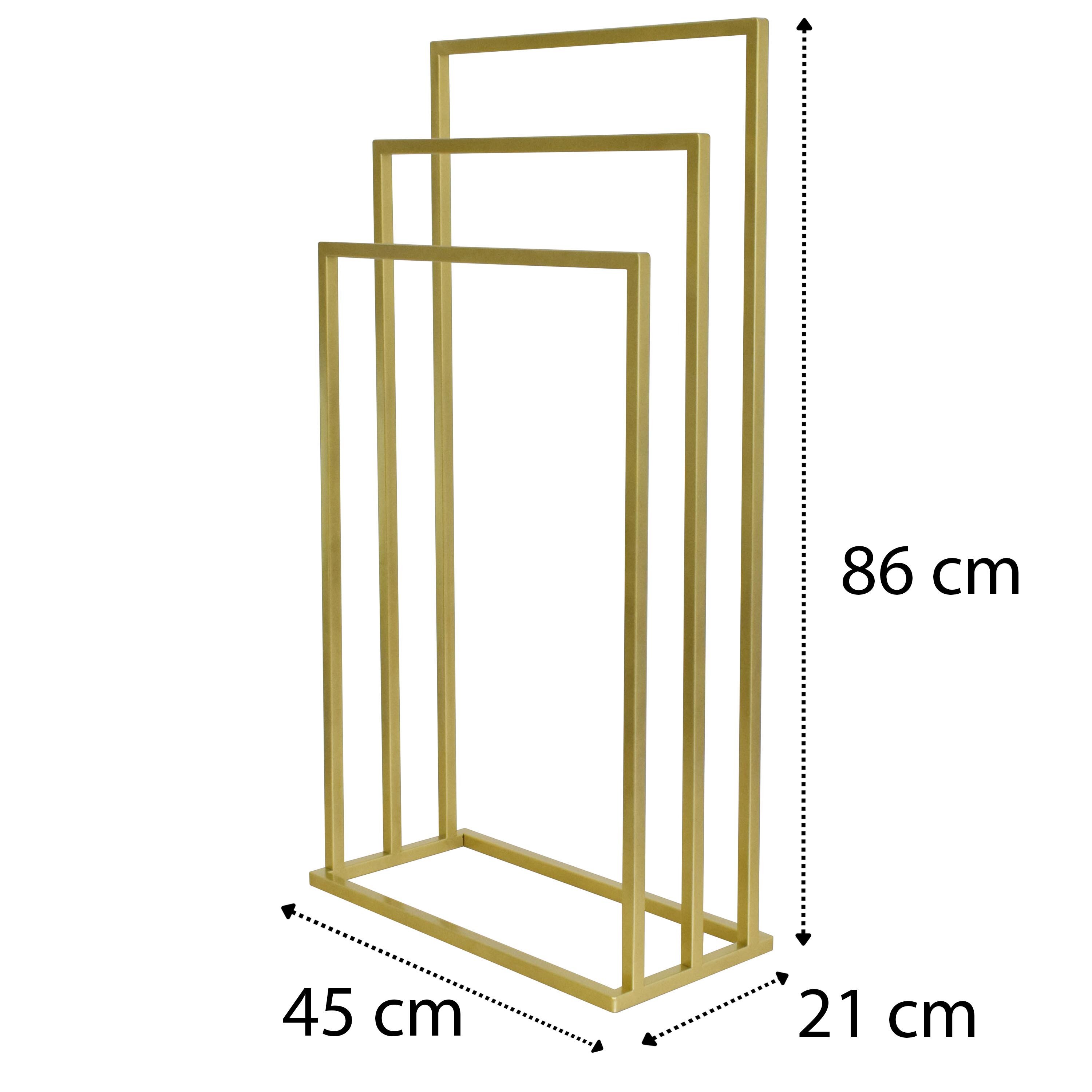 Złoty stojak na ręczniki z trzema ramionami, o wymiarach 86 cm wysokości, 45 cm szerokości i 21 cm głębokości.
