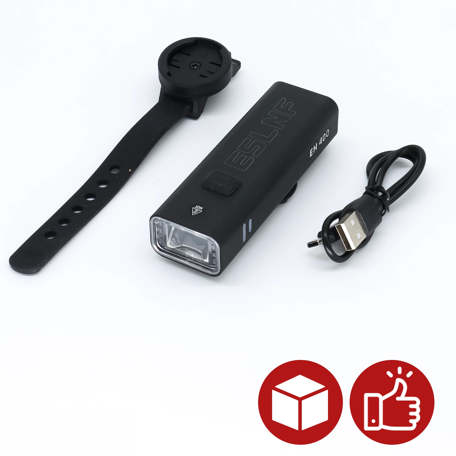 Na obrazie znajduje się czarna lampka rowerowa z napisem \'ESLNF EH 400\', czarny pasek montażowy oraz kabel USB. W dolnym rogu widoczne są dwie czerwone ikony: pudełko i kciuk w górę.