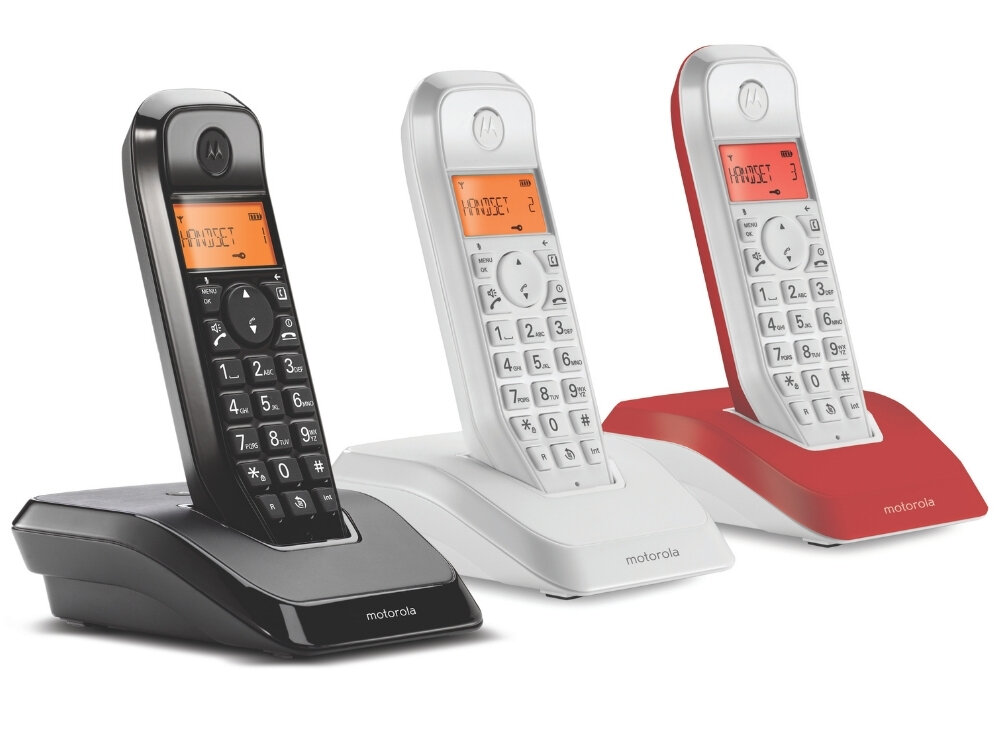 Trzy bezprzewodowe telefony stacjonarne w różnych kolorach: czarnym, białym i czerwonym, każdy z wyświetlaczem pokazującym tekst \'BASE 1\'. Na podstawach telefonów widoczne jest logo \'motorola\'.