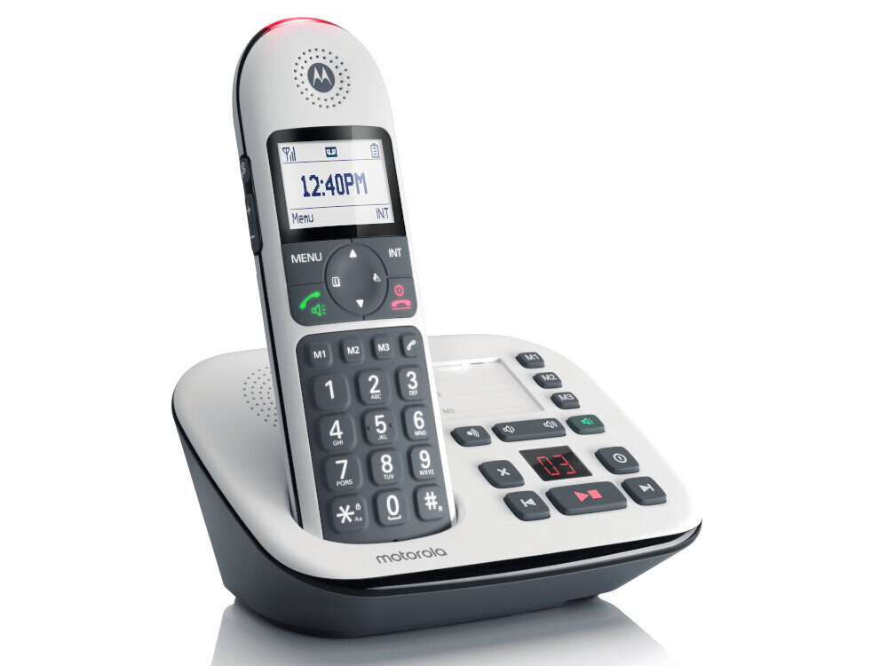 Na obrazie widoczny jest biały telefon stacjonarny z dużymi przyciskami i wyświetlaczem pokazującym godzinę 12:40 PM. Na podstawie telefonu znajduje się logo \'motorola\'.