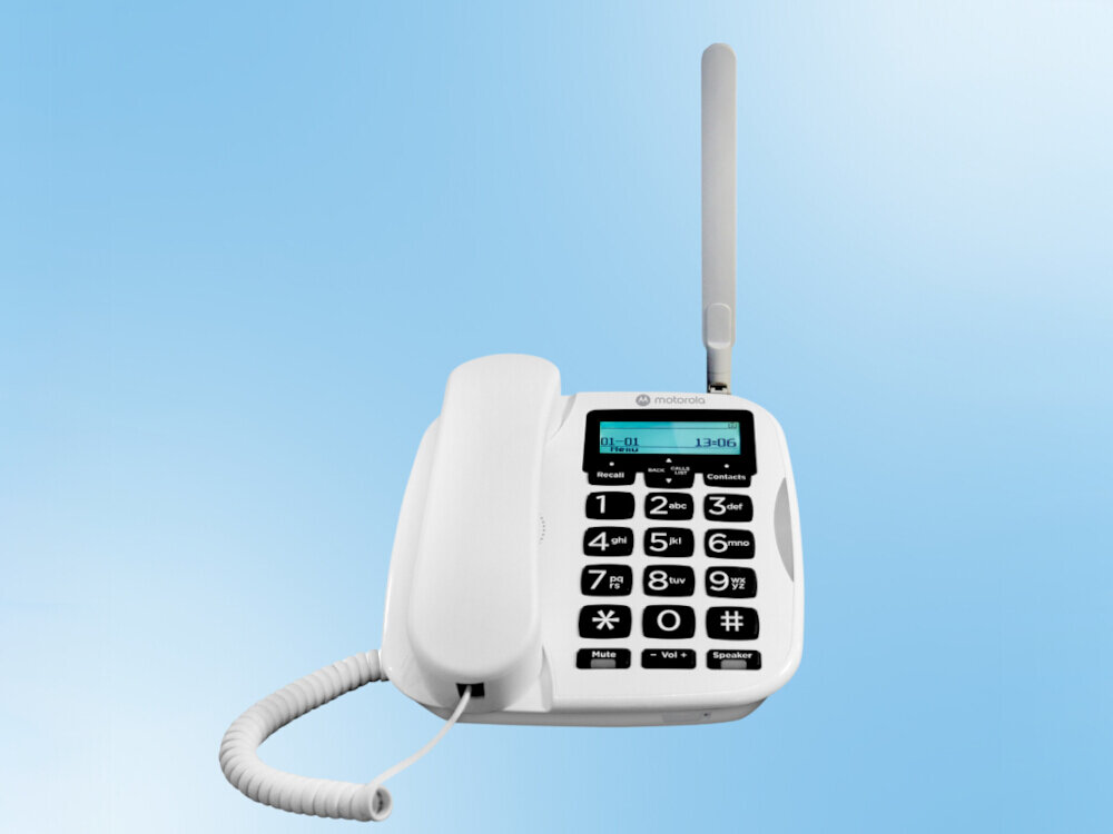 Biały telefon stacjonarny z dużymi przyciskami numerycznymi i wyświetlaczem LCD. Na obudowie widoczne jest logo \'motorola\'.