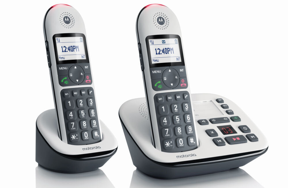 Na obrazie widoczne są dwa białe telefony bezprzewodowe z dużymi przyciskami, umieszczone na stacjach dokujących. Na wyświetlaczach obu telefonów widnieje godzina 12:40 PM, a poniżej znajduje się logo motorola.