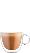 Obraz przedstawia filiżankę z kawą typu flat white. Nad filiżanką znajduje się tekst: \'FLAT WHITE\'.