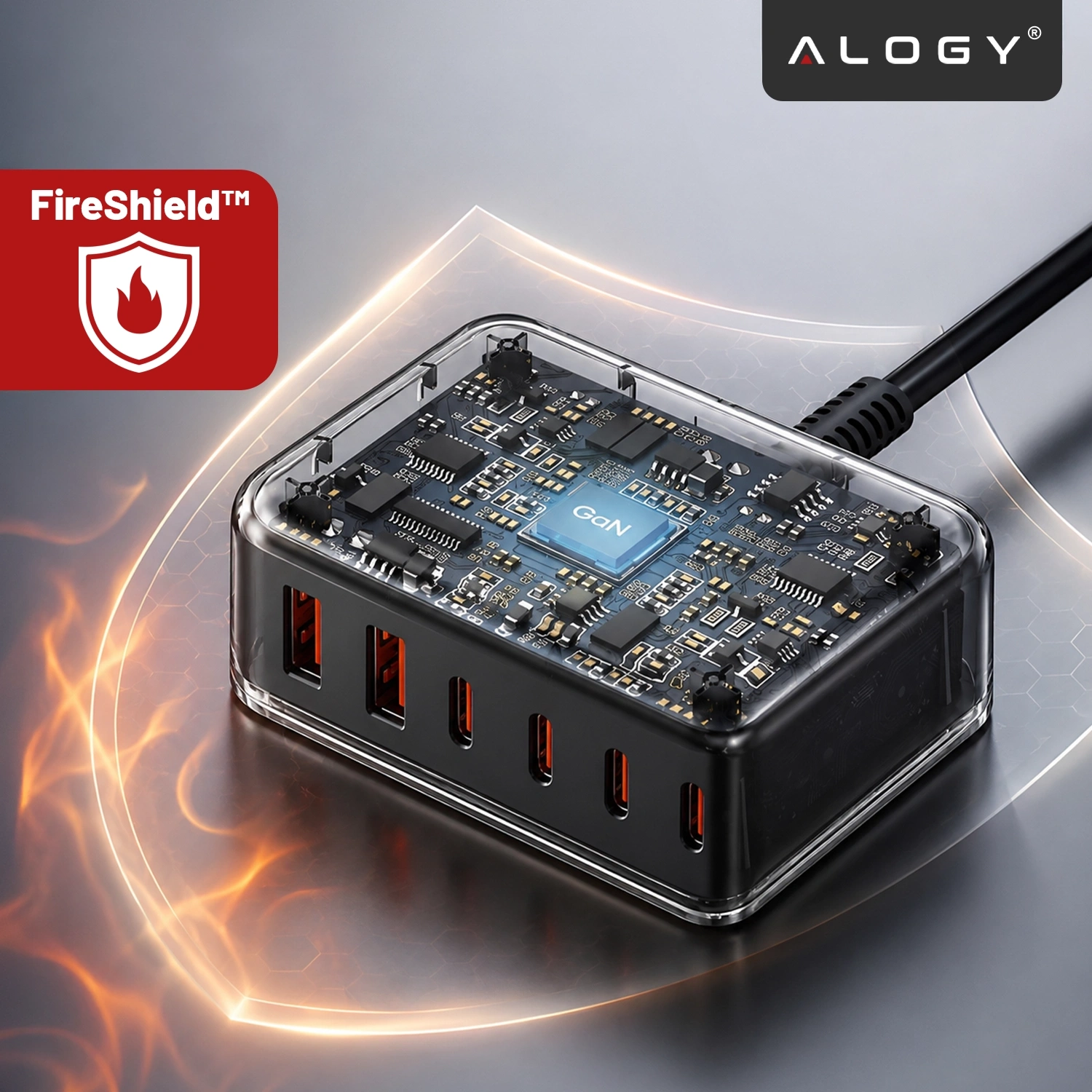 Obraz przedstawia przezroczystą ładowarkę z widocznymi komponentami elektronicznymi i sześcioma portami USB. W lewym górnym rogu znajduje się czerwone logo z napisem \'FireShield™\', a w prawym górnym rogu logo \'ALOGY\'.