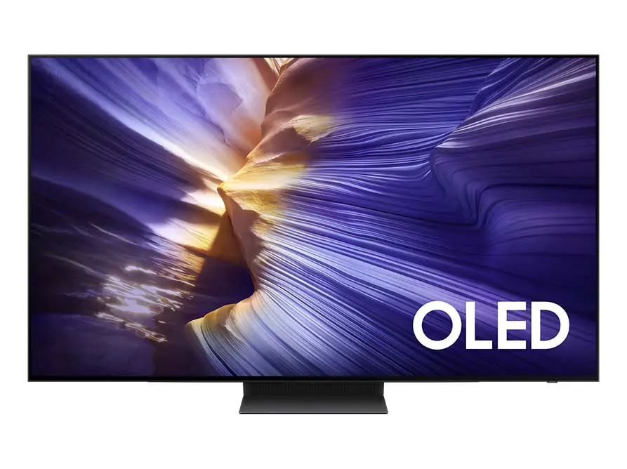 893x668-qe65s95fatxxh Telewizor z wyświetlaczem prezentującym abstrakcyjny obraz w odcieniach fioletu i złota. W prawym dolnym rogu widoczny jest napis \'OLED\'.