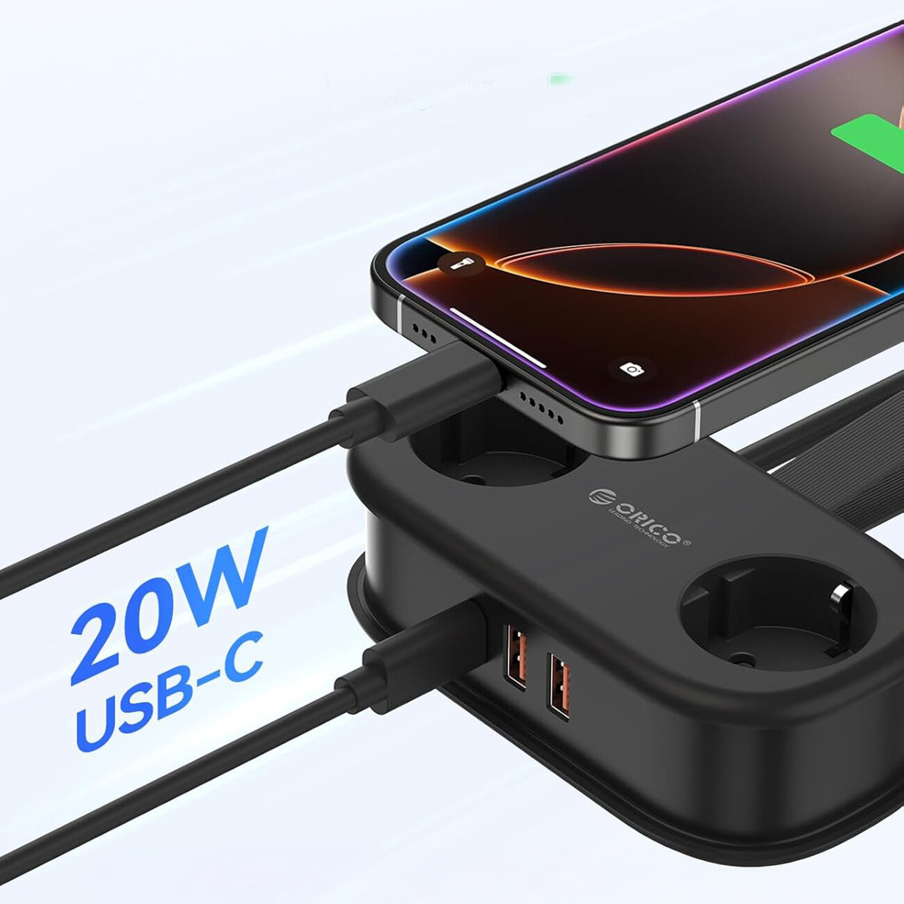 Czarna listwa zasilająca z dwoma gniazdami AC, dwoma portami USB-A i jednym USB-C, na której leży telefon podłączony do ładowania. Widoczny tekst: \'20W USB-C\'.