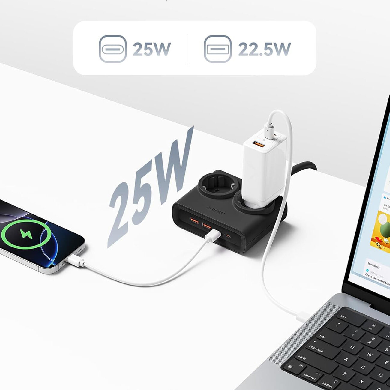 Na białym biurku znajduje się czarna listwa zasilająca z dwoma gniazdami AC i czterema portami USB, do której podłączone są urządzenia elektroniczne. Widoczny jest napis \'25W\' oraz \'22.5W\'.