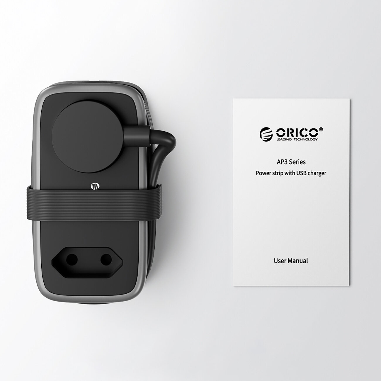 Na obrazie widoczna jest czarna listwa zasilająca z przewodem oraz instrukcja obsługi z tekstem: \'ORICO Leading Technology AP3 Series Power strip with USB charger User Manual\'.
