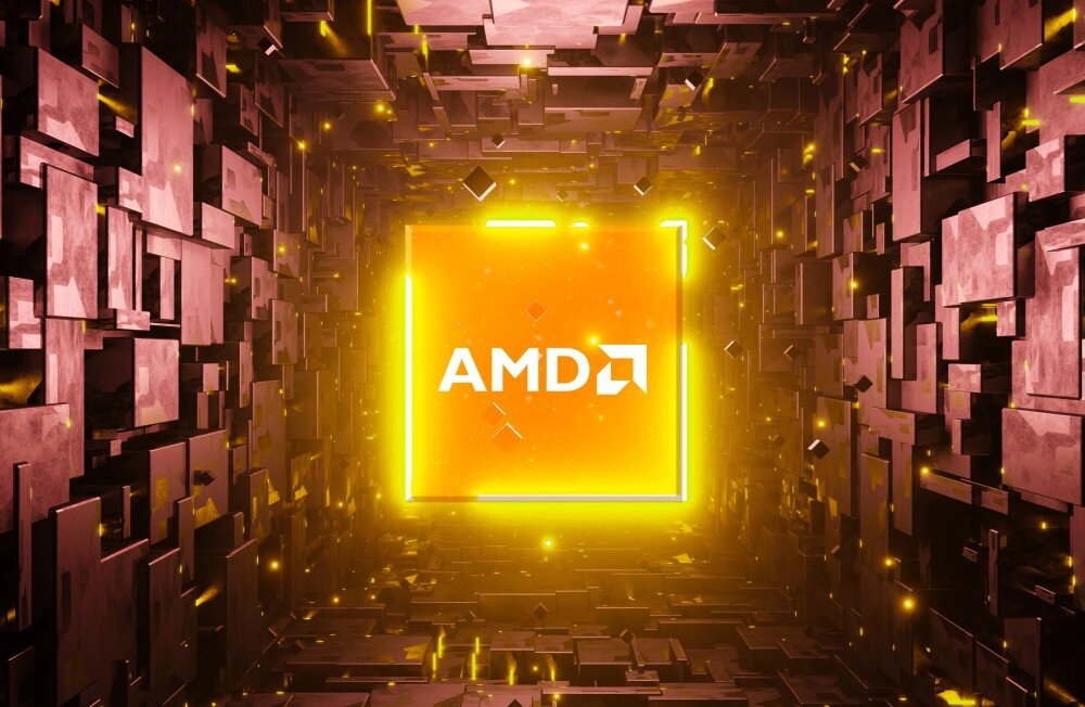 Komputer ACER Nitro N30-100 Centralnie umieszczone logo 'AMD' na świecącym na żółto kwadratowym tle, otoczone trójwymiarową strukturą z metalicznych klocków