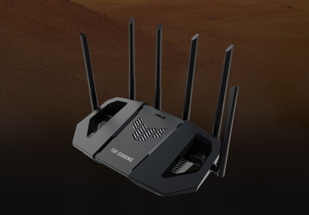 Na obrazie widoczny jest czarny router z sześcioma antenami, z logo \'ASUS\' i napisem \'TUF GAMING\' na obudowie. Tło jest ciemne, przypominające powierzchnię Marsa.