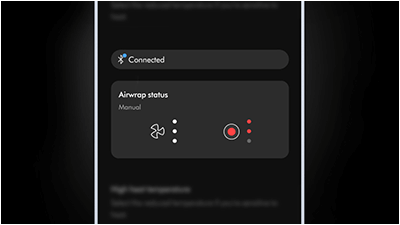 Interfejs użytkownika z napisem \'Connected\' oraz sekcją \'Airwrap status Manual\' z ikonami wentylatora i przycisku z czerwonymi kropkami.