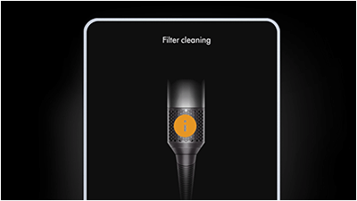 Obraz przedstawia suszarko-lokówkę z widocznym napisem \'Filter cleaning\'. Na urządzeniu znajduje się pomarańczowe kółko z literą \'i\'.