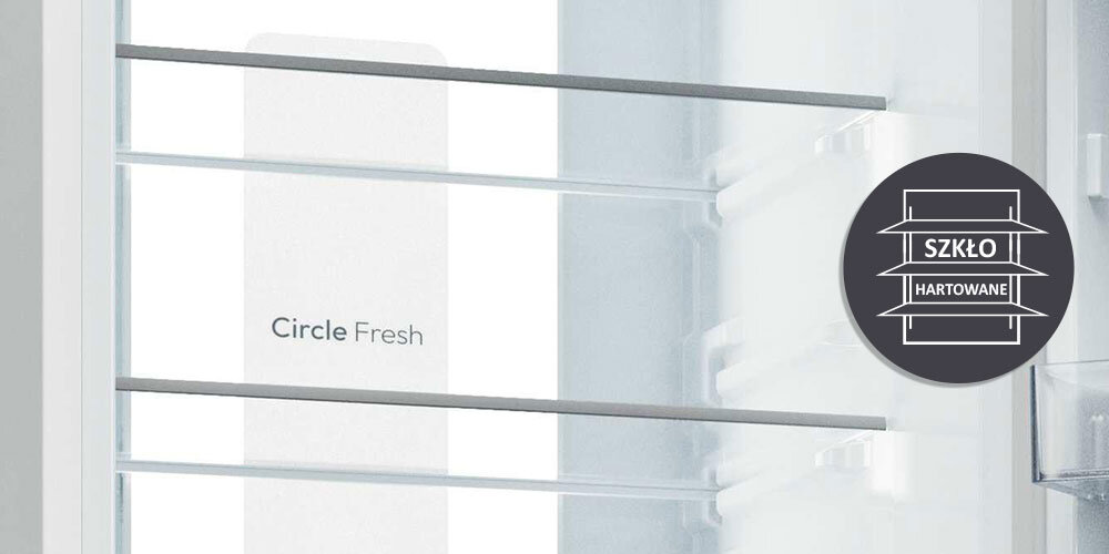 Wnętrze lodówki z widocznymi szklanymi półkami i napisem \'Circle Fresh\'. Obok znajduje się okrągła grafika z napisem \'SZKŁO HARTOWANE\'.