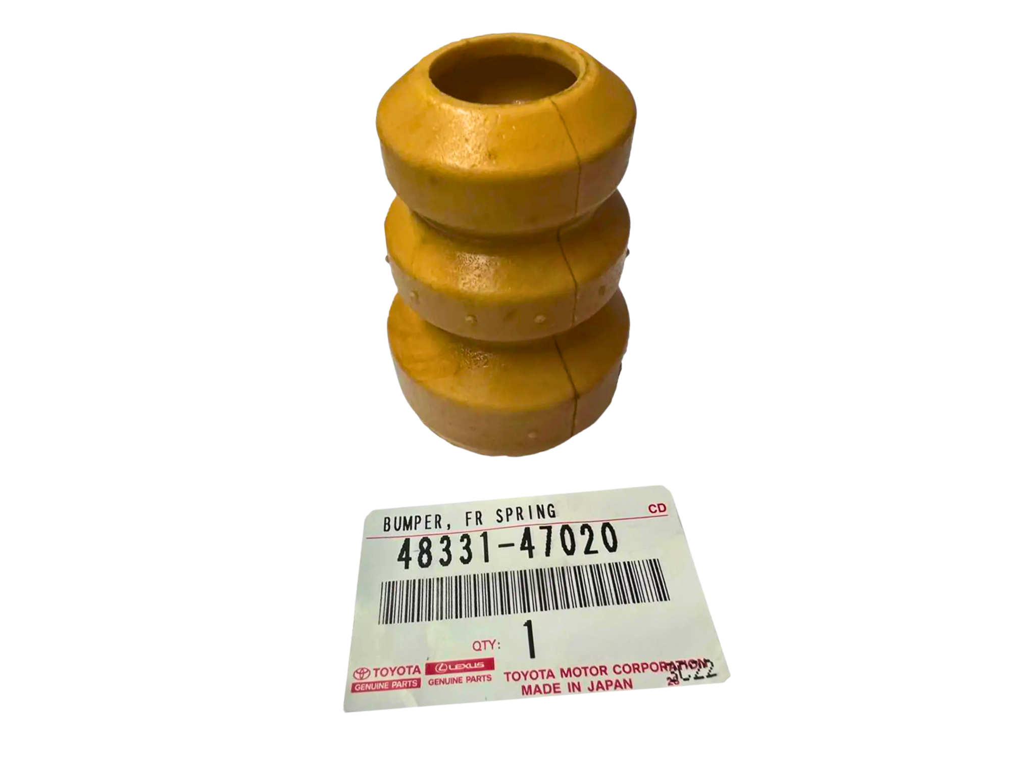 Na obrazie widoczny jest żółty element przypominający odbojnik amortyzatora oraz etykieta z tekstem: \'BUMPER, FR SPRING 48331-47020 QTY: 1 TOYOTA MOTOR CORPORATION MADE IN JAPAN\'.