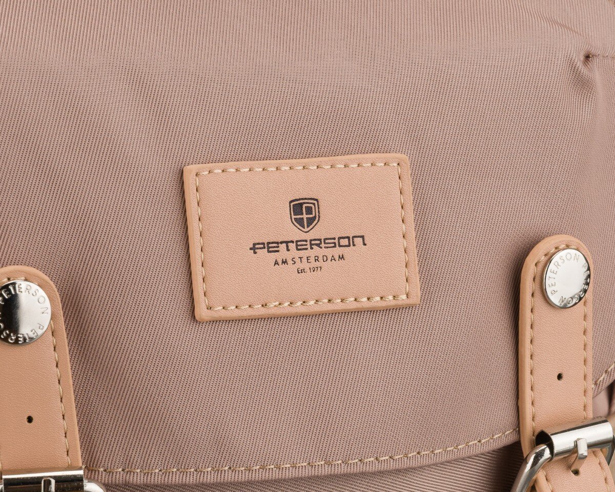 Beżowy plecak z widocznym logo \'PETERSON AMSTERDAM Est. 1977\' na skórzanej naszywce. Metalowe elementy z napisem \'PETERSON\'.