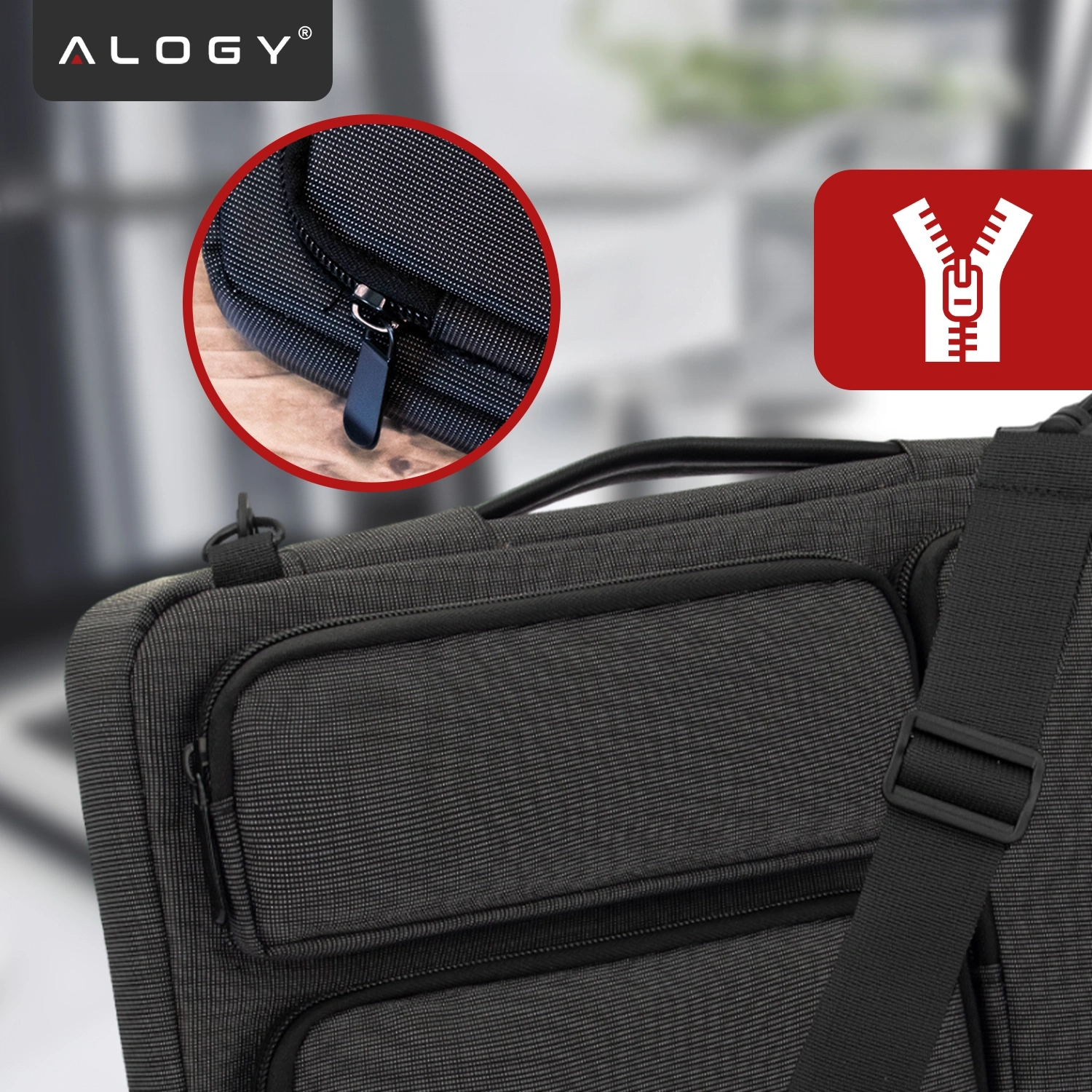 Czarna torba na laptopa z paskiem na ramię, widoczna zbliżenie na zamek błyskawiczny. Logo \'ALOGY\' w lewym górnym rogu oraz ikona zamka błyskawicznego na czerwonym tle.